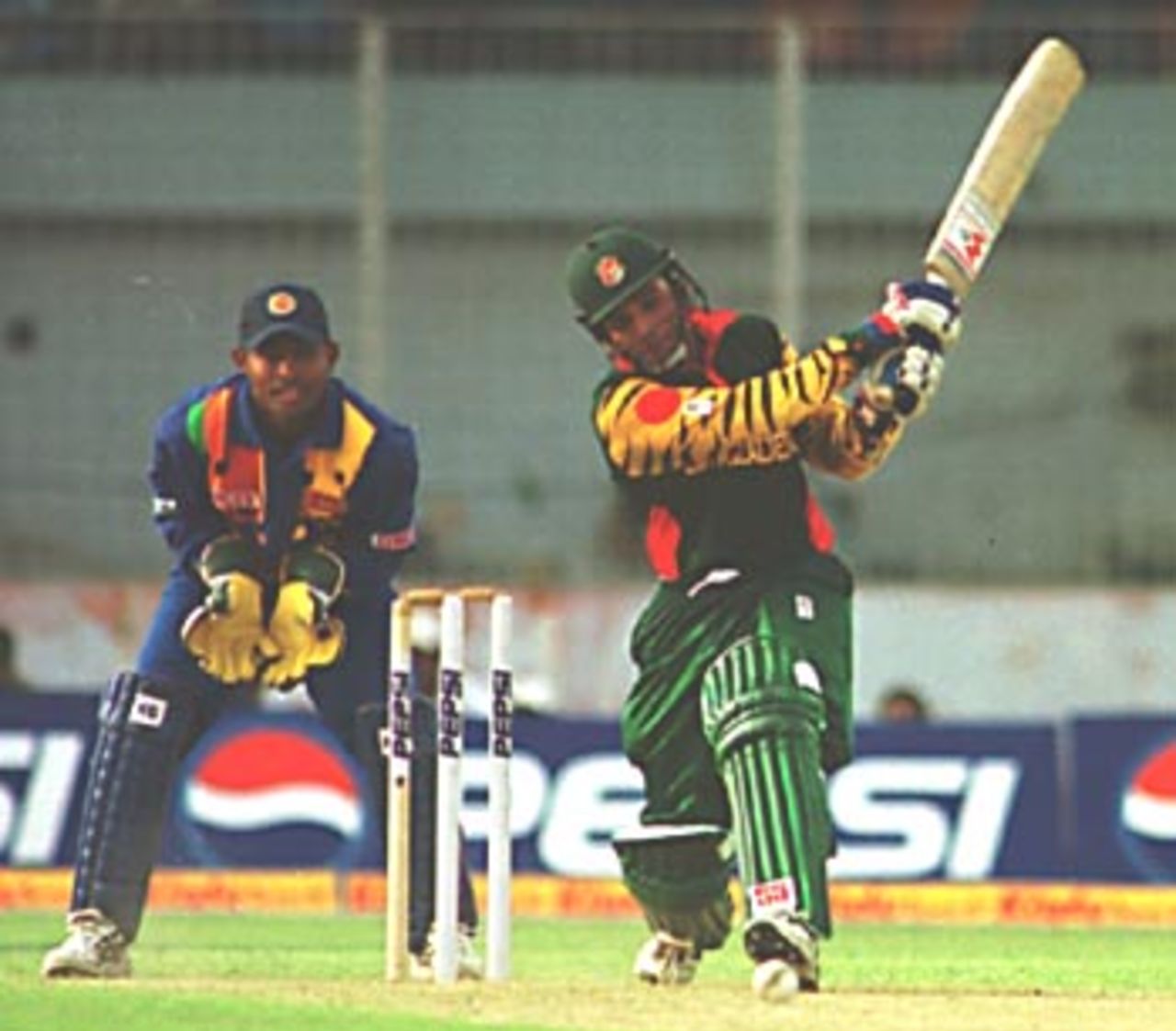 Javed Omar, the top scorer for Bangladesh, smashes the ball to mid-off, Asia Cup 1999/00, Bangladesh v Sri Lanka, Bangabandhu National Stadium, Dhaka 29 May 2000