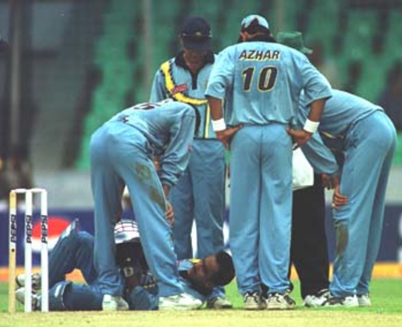 Anxious Indian team members surrounding the injured Saba Karim, Asia Cup 1999/00, 2nd Match, Bangladesh v India, Bangabandhu National Stadium, Dhaka 30 May 2000