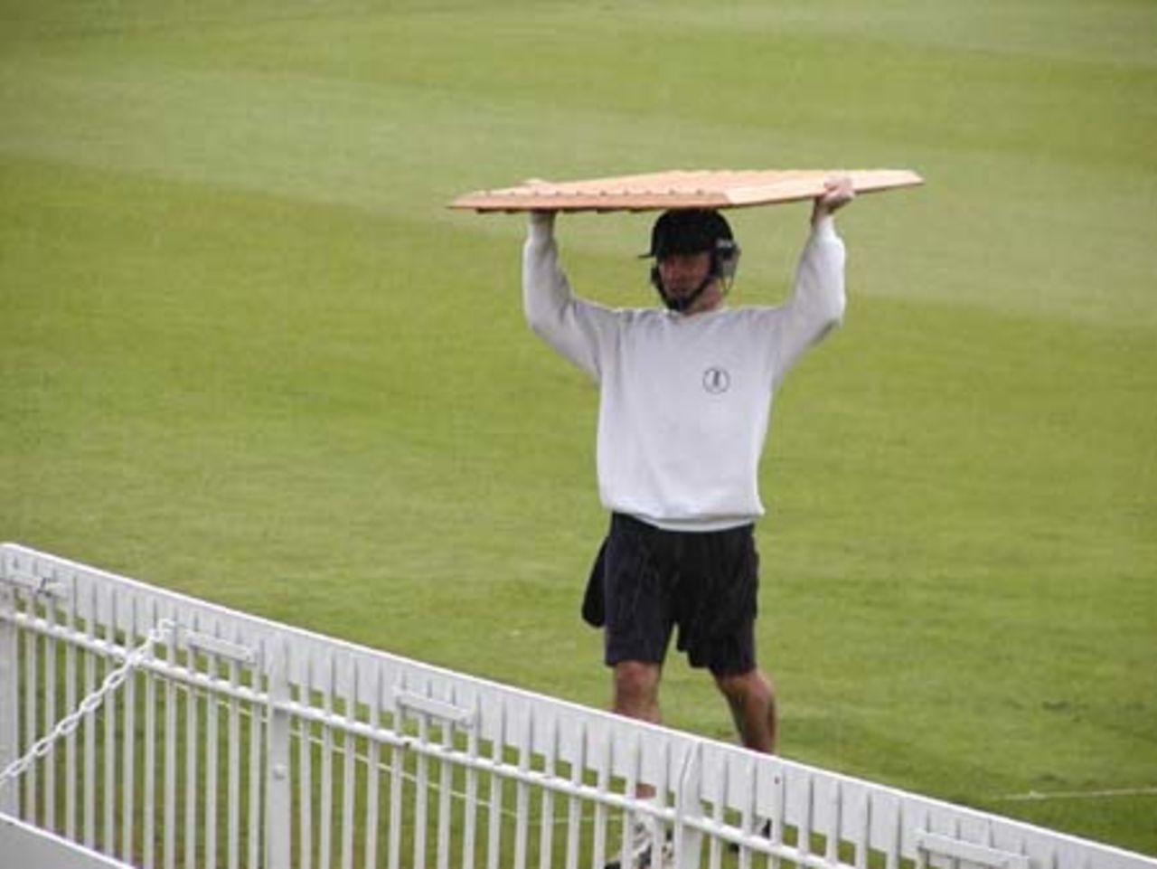 Andy Bones, Oxford UCCE wicket-keeper protects himself from another downpour