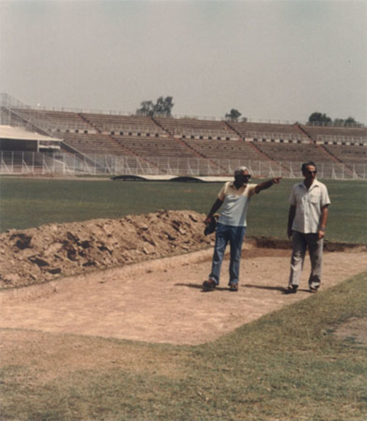 Gul Mohammad(left) and Col Rafi Nasim supervising construction of pitches at Gaddafi Stadium Lahore.