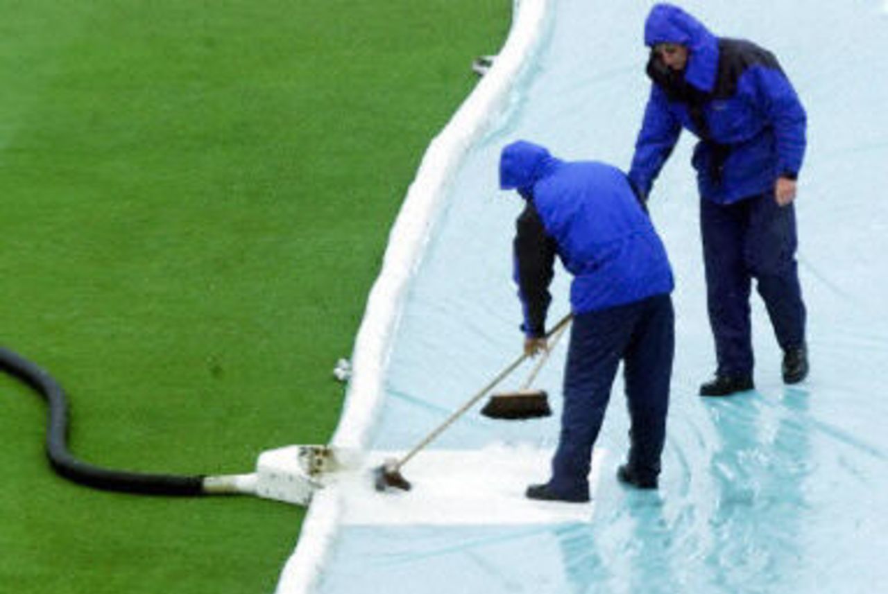 Groundsmen sweep away surface water after the rain, day 1, 1st Test at Lord's, 17-21 May 2001.