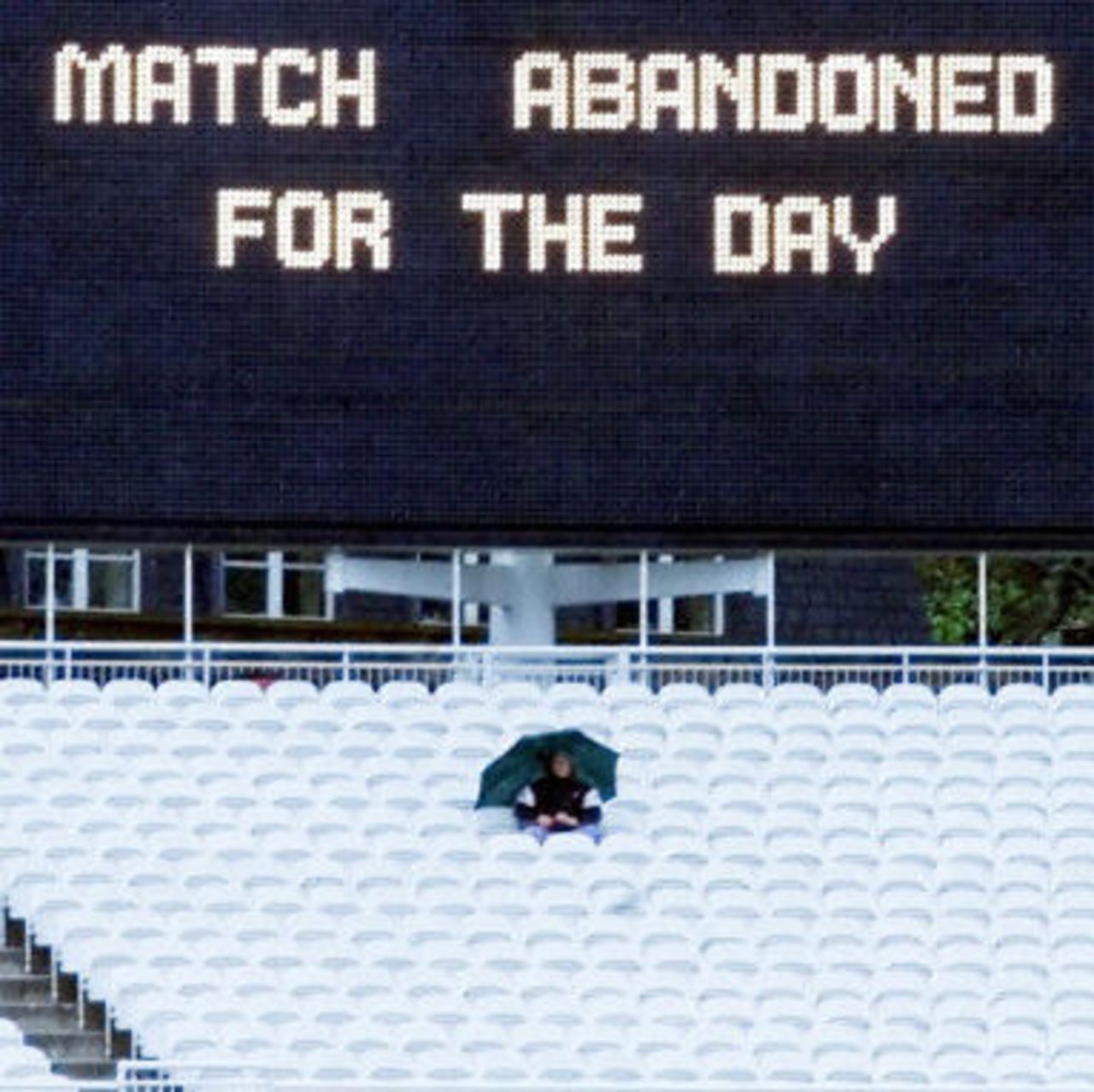 A lone cricket fan braves the rain, day 1, 1st Test at Lord's, 17-21 May 2001.