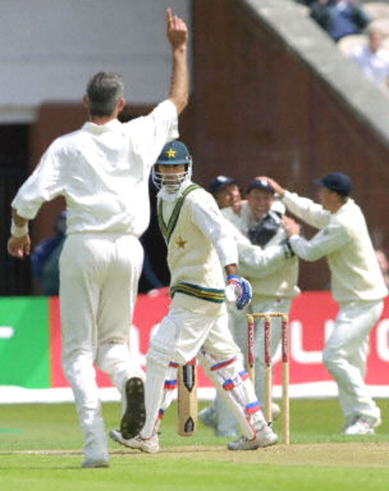 Saeed Anwar watches Andrew Caddick celebrate his dismissal after he was caught by Michael Atherton, day 1, 2nd Test at Old Trafford, 31 May - 4 June 2001.
