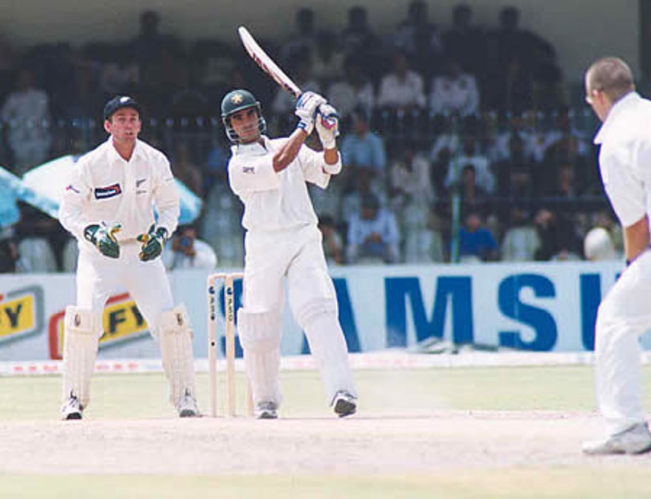 Imran Nazir drives Daniel Vettori, while Robbie Hart looks on - day 1, 1st Test, New Zealand v Pakistan, Gaddafi Stadium Lahore, 1 May 2002