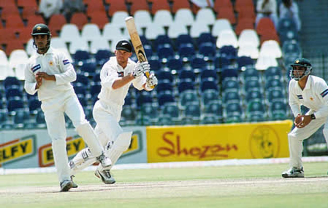 Lou Vincent drives to point as Imran Nazir takes evasive action, during his knock of 57 - New Zealand second innings, day 3, 1st Test, New Zealand v Pakistan, Gaddafi Stadium Lahore, 3 May 2002