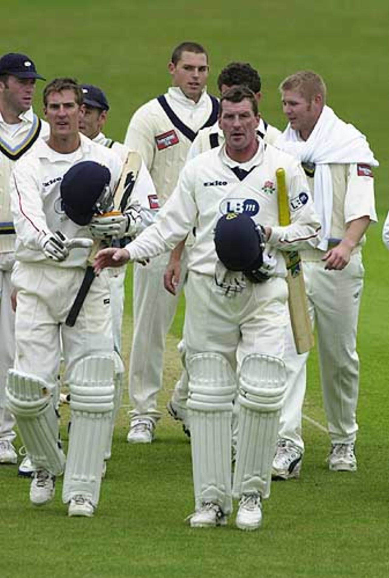 Mark Chilton left, and David Byas leave the field victorious for Lancashire