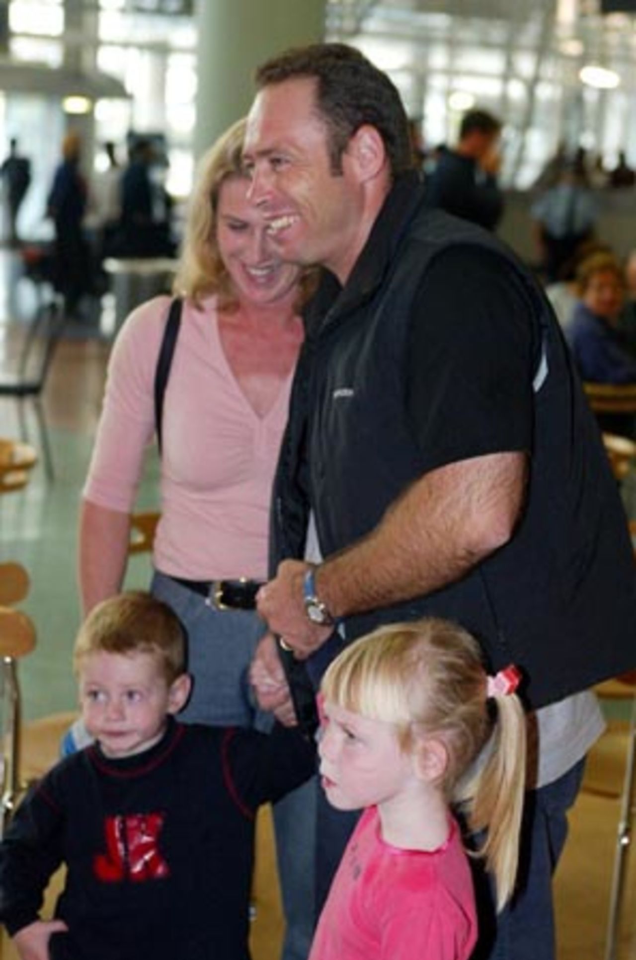 Radio and television commentator and former New Zealand player Danny Morrison meets his family after arriving at Auckland Airport. He returned home with the New Zealand team from Pakistan after a bomb blast outside their Karachi hotel caused the tour to be cancelled just prior to the second Test. 10 May 2002.
