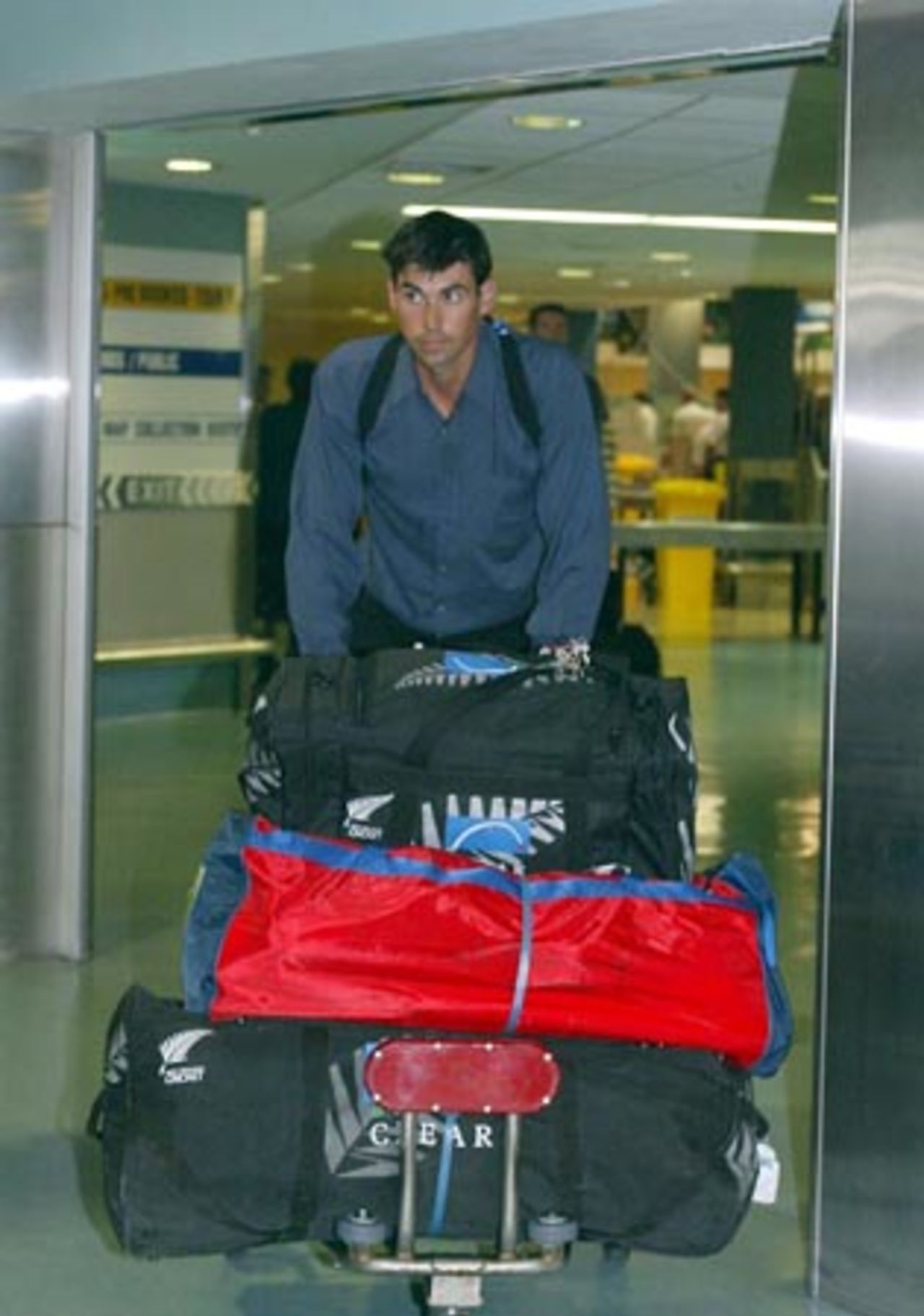 New Zealand captain Stephen Fleming enters the arrivals hall at Auckland Airport. The New Zealand team returned from Pakistan after a bomb blast outside their Karachi hotel caused the tour to be cancelled just prior to the second Test. 10 May 2002.