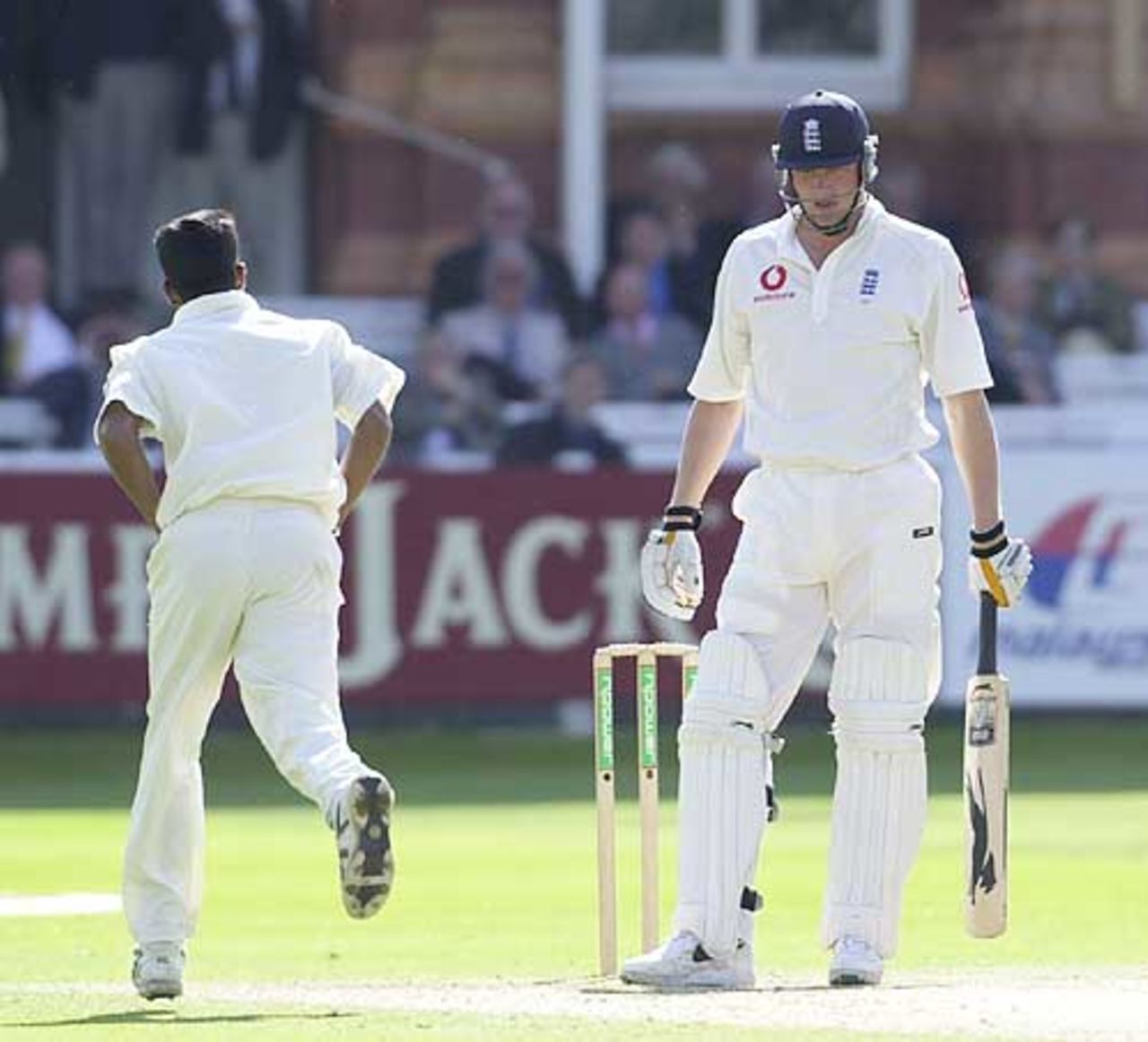 Rueful Freddie Flintoff as victorious bowler Fernando runs past him, Flintoff caught behind for 12, England v Sri Lanka, First Test, Lord's 2002