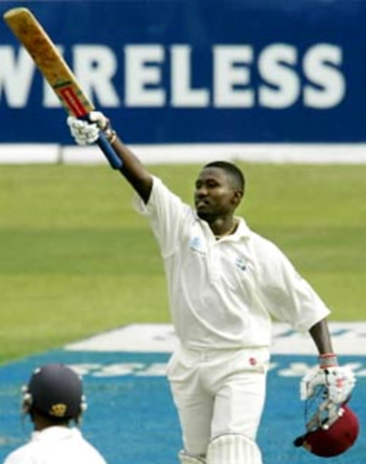 Wavell Hinds lifts his bat after reaching three figures against India at Jamaica