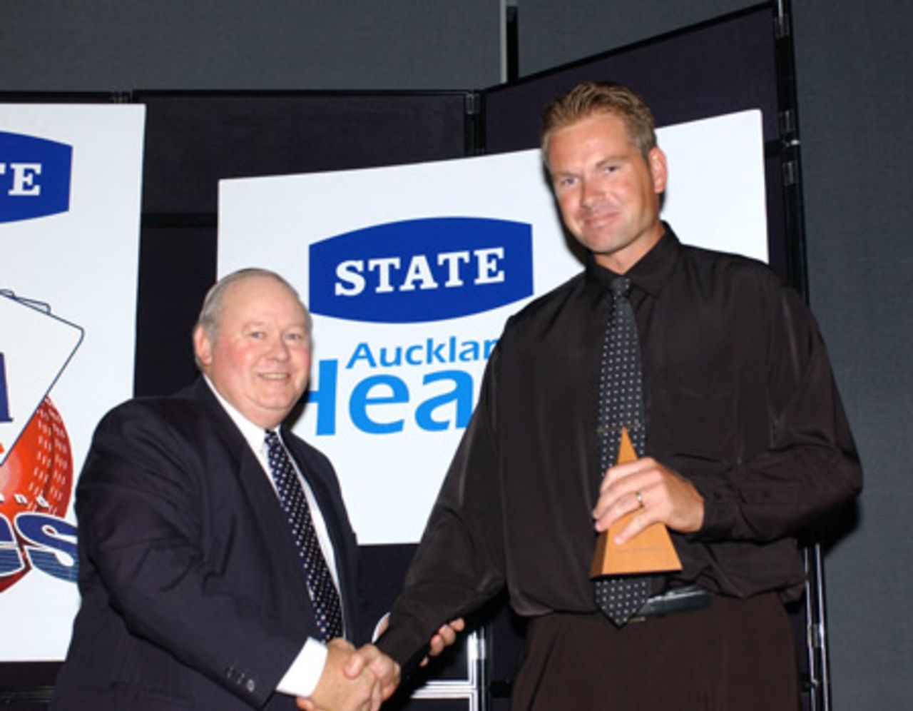 Auckland player Aaron Barnes (right) is presented the batsman of the year award by Auckland Cricket Association president Ray Hopkins. Auckland Cricket Association awards dinner at the ASB Bank Lounge, Eden Park, Auckland, 2 April 2003.
