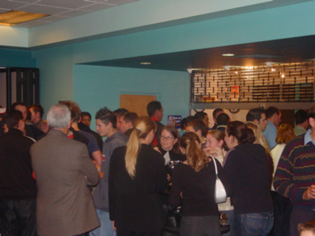 Attendees enjoy a few drinks courtesy of the Auckland Cricket Association. Crown Relocations Auckland Association club prizegiving evening, West Stand, Eden Park, Auckland, 13 May 2003.
