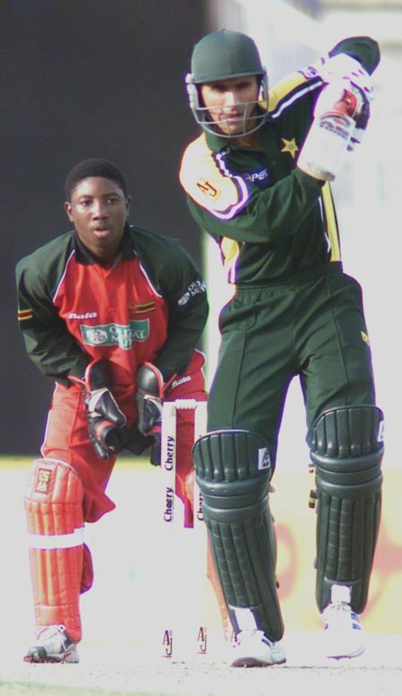Abdul Razzaq drives as Tatenda Taibu looks on, 1st Match: Pakistan v Zimbabwe, Cherry Blossom Sharjah Cup, 3 April 2003