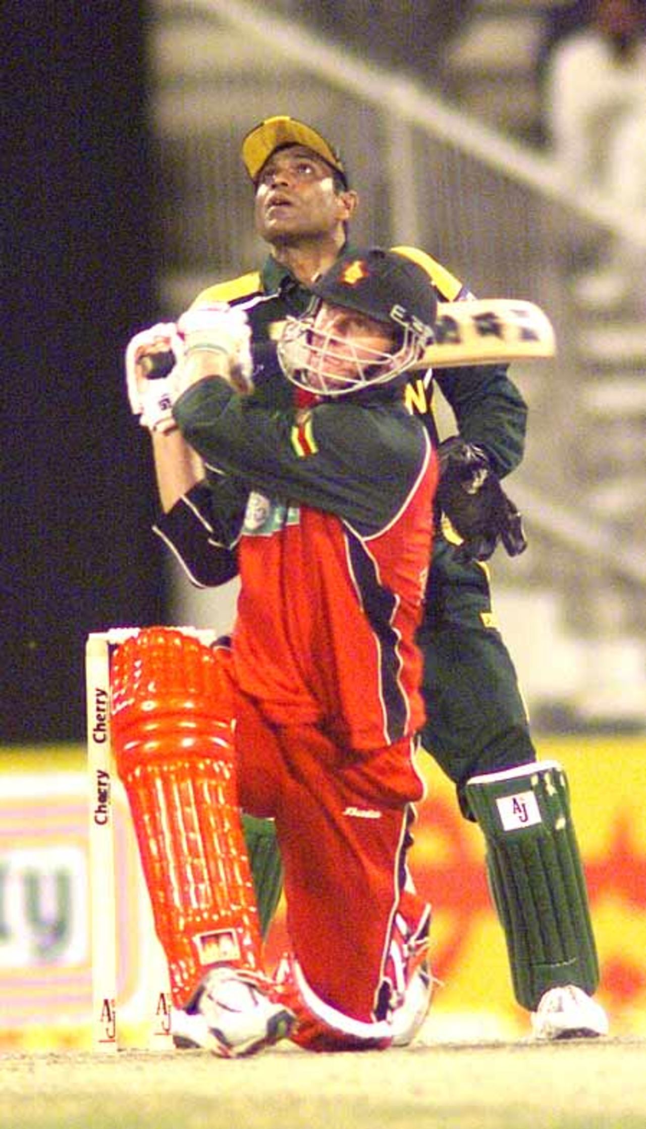 Andy Blignaut hoiks this one as Rashid Latif looks on, 1st Match: Pakistan v Zimbabwe, Cherry Blossom Sharjah Cup, 3 April 2003