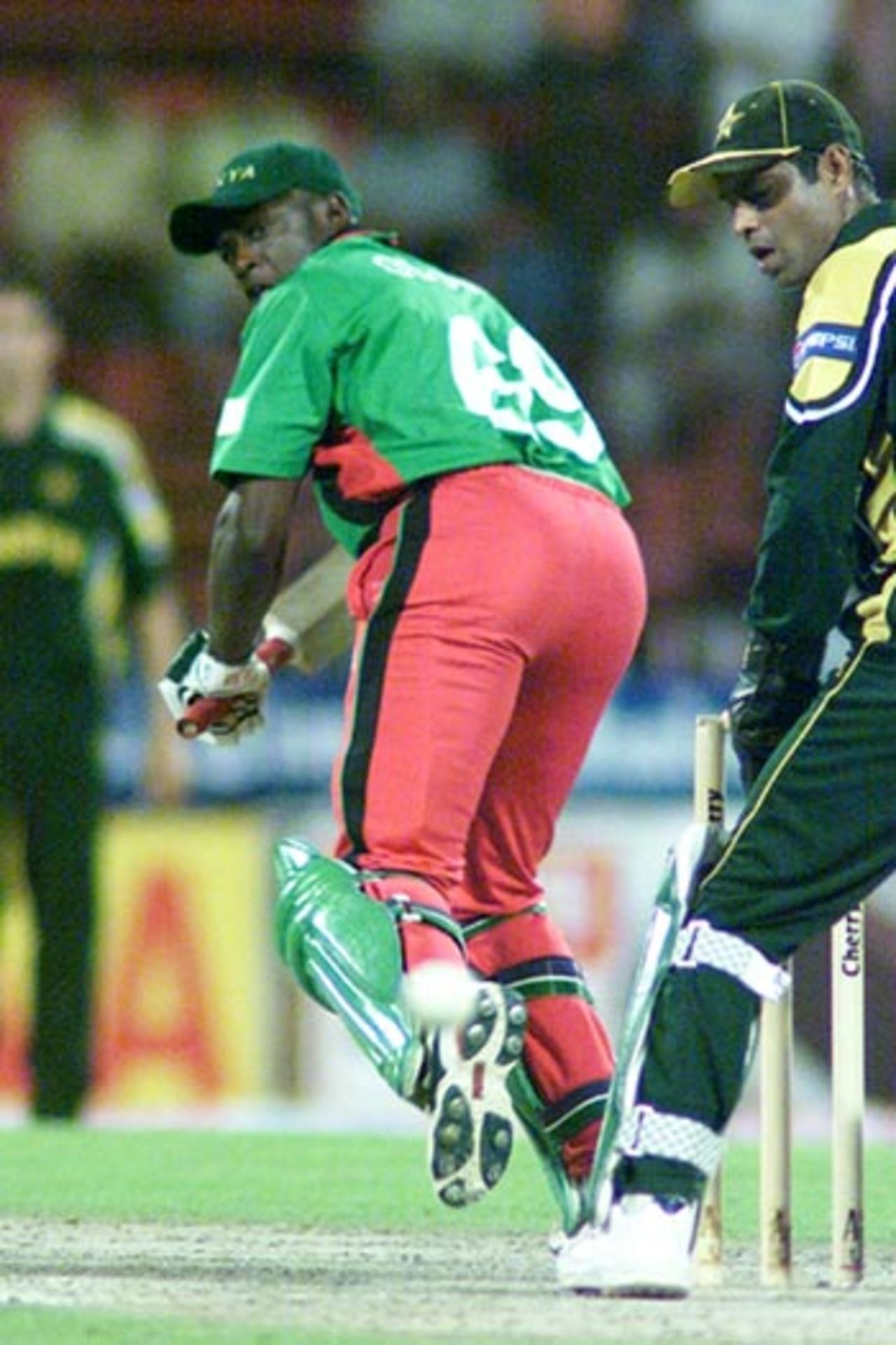 Odumbe has tickled a ball past Pakistani keeper Rashid Latif, 6th Match: Kenya v Pakistan, Cherry Blossom Sharjah Cup, 8 Apr 2003