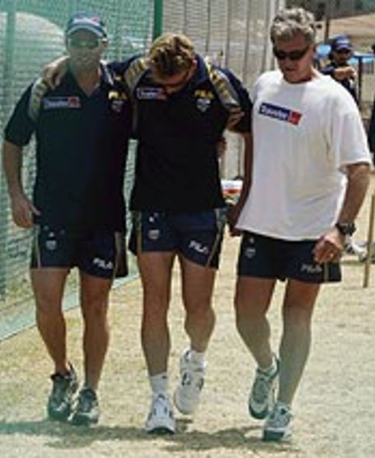 Brett Lee is led away with concussion after being struck on the back of the neck
