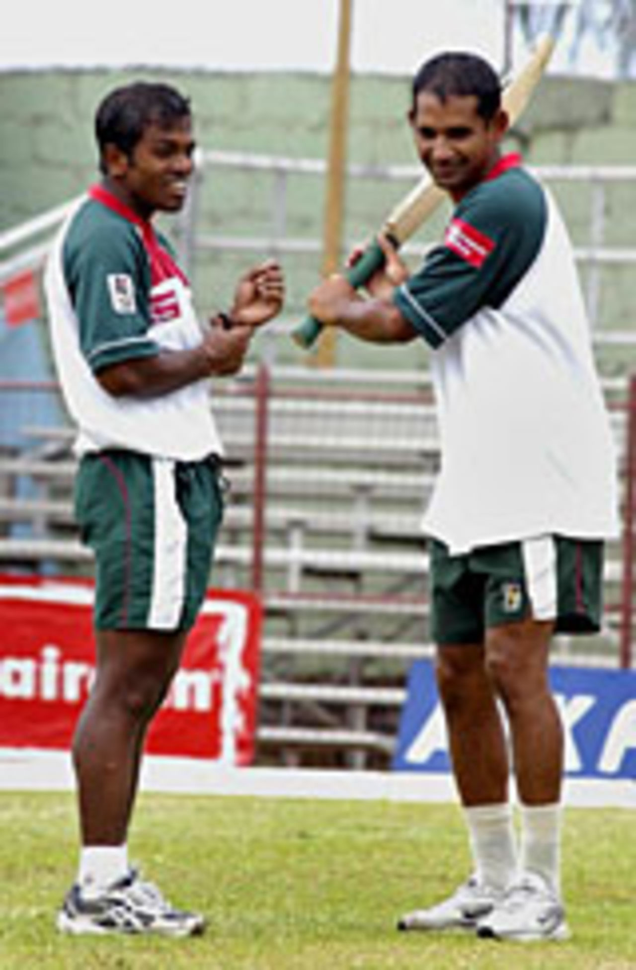 Bangladesh's Rajin Saleh (left) makes a point to Habibul Bashar ahead of Saturday's opening one-dayer, St Vincent, May 14, 2004