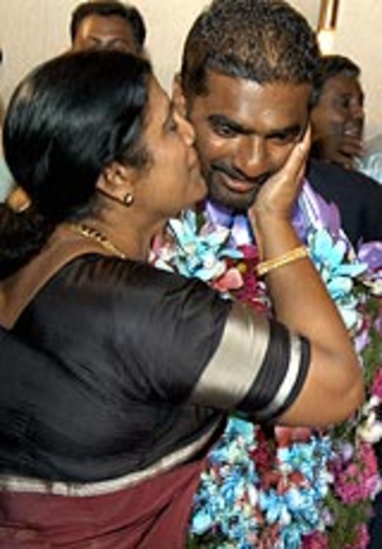 Muttiah Muralitharan being kissed by his mother after his triumphant return from Zimbabwe, May 20, 2004