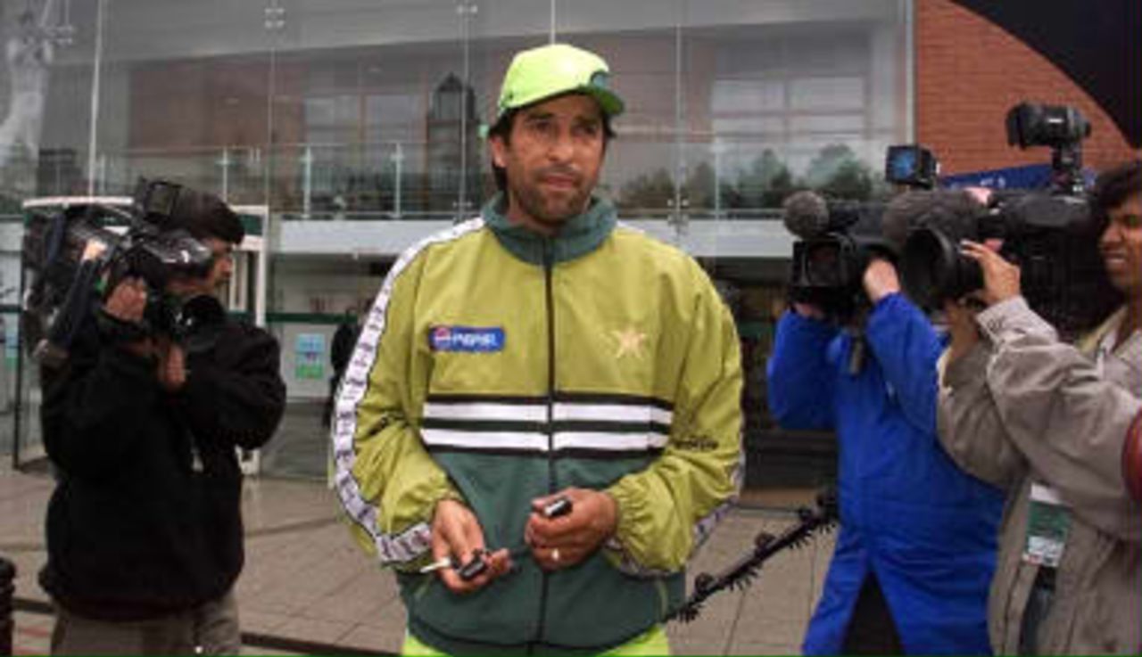Pakistan captain Wasim Akram leaves the Old Trafford ground in Manchester 07 June 1999 after heavy rain flooded his sides practice session ahead of the 08 June 1999 clash with India