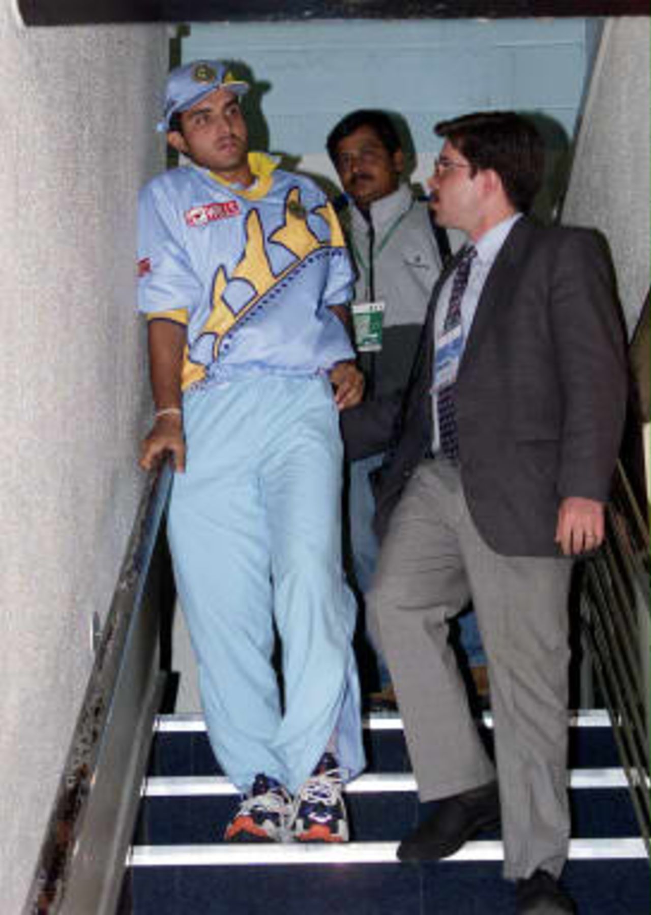 India's opening batsman Saurav Ganguly limps down the stairs as he talks to a journalist after watching his team during indoor practise, after this morning's practises for India and Pakistan were cancelled because of the water-logged Old Trafford pitch.