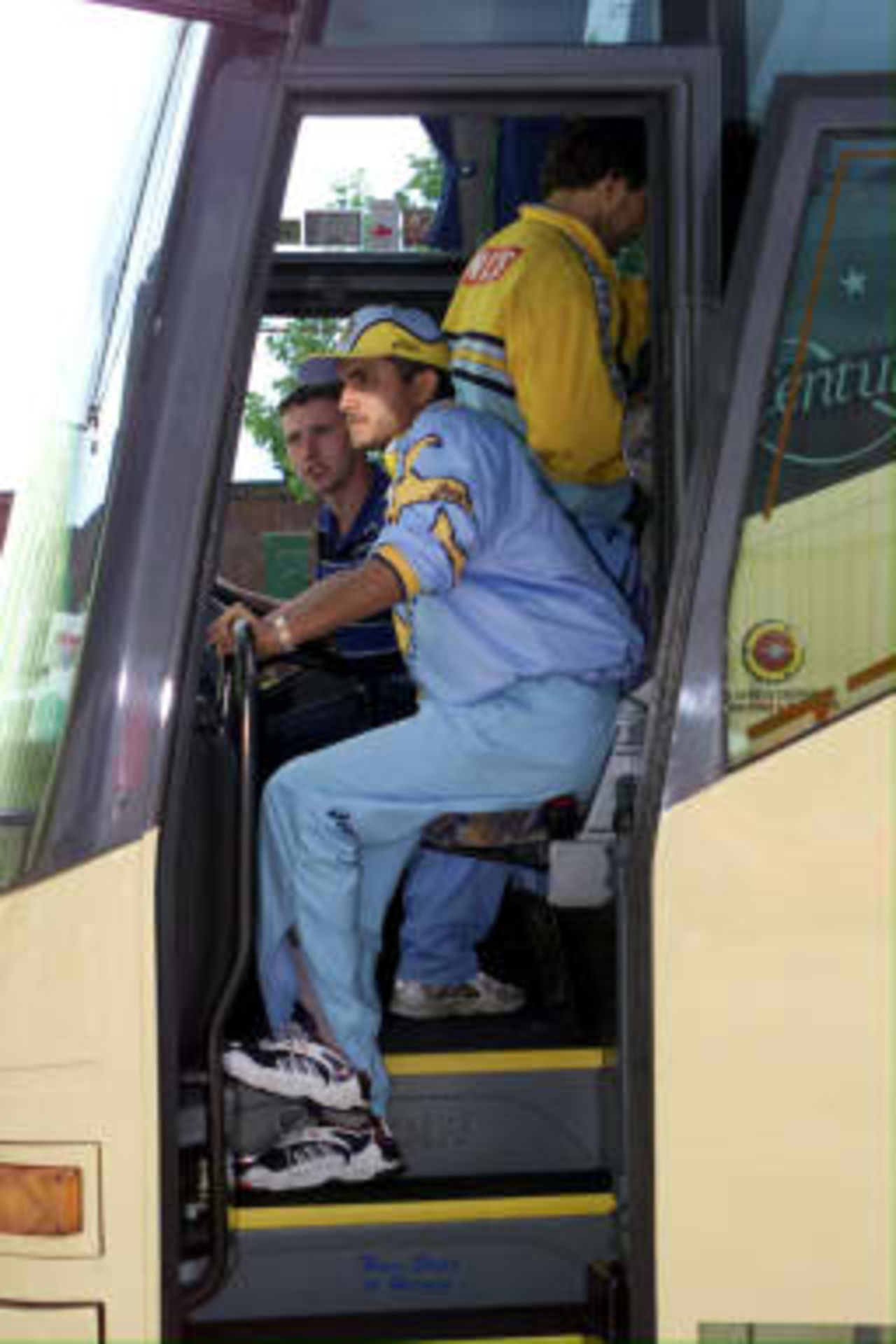 India's opening batsman Saurav Ganguly sits awkwardly on the team coach after injuring his right leg.