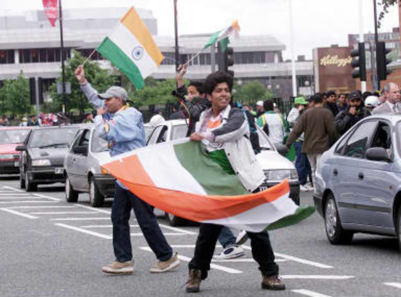 Enthusiastic Indian fans dance in the streets holding up traffic 08 June 1999, before todays Cricket World Cup match against Pakistan at Old Trafford, Manchester. The final will be at Lords on the 20 June 99