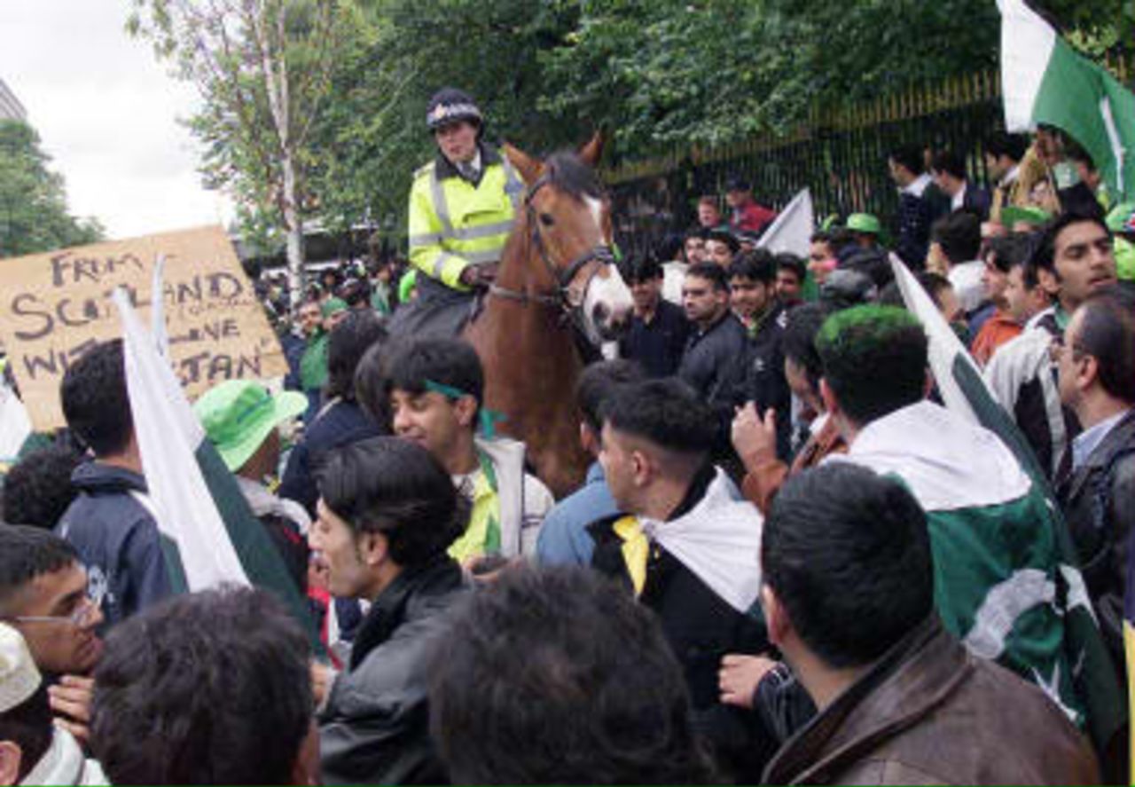 Supporters of the Pakistan team are spread out by a mounted police officer in an effort to avoid confrontation with Indian fans across the main road outside Old Trafford cricket ground, prior to the Super Six match of the Cricket World Cup match in Manchester 08 June 1999