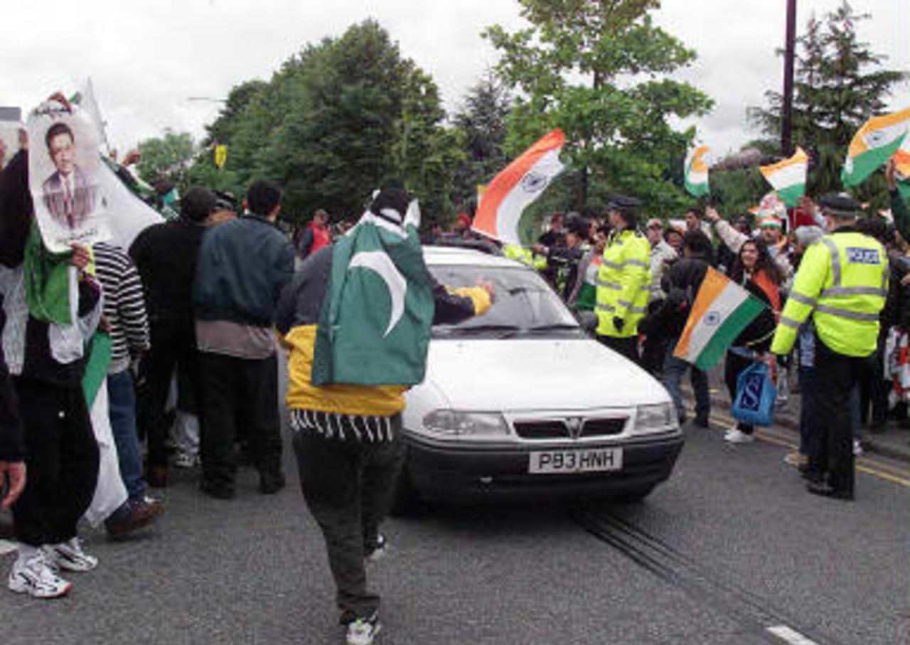 Supporters of the Pakistan and Indian teams confront one another across the main road outside Old Trafford cricket ground, prior to their 08 June 1999 super six match of the Cricket World Cup match in Manchester