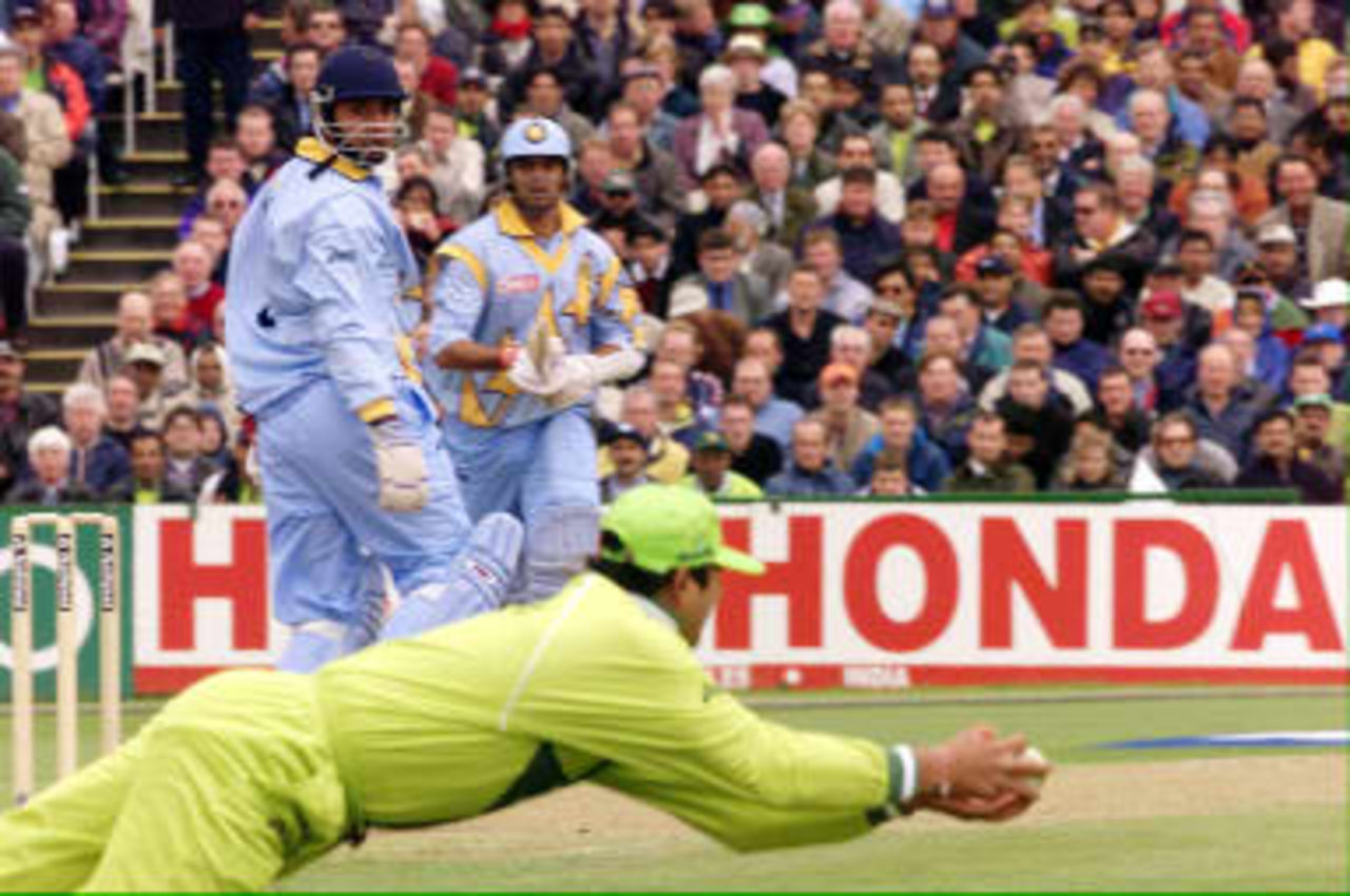 Pakistan Inzamam-ul-Haq makes a diving catch to dismiss Ajay Jadeja (L) watched by Rahul Dravid 08 June 99, during their Cricket World Cup match at Old Trafford, Manchester