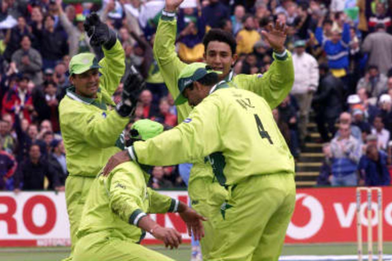 Pakistan first slip Inzamam-ul-Haq is congratulated by team mates after making a diving catch to dismiss India's Ajay Jadeja (L)  08 June 1999 during their Cricket World Cup match at Old Trafford, Manchester