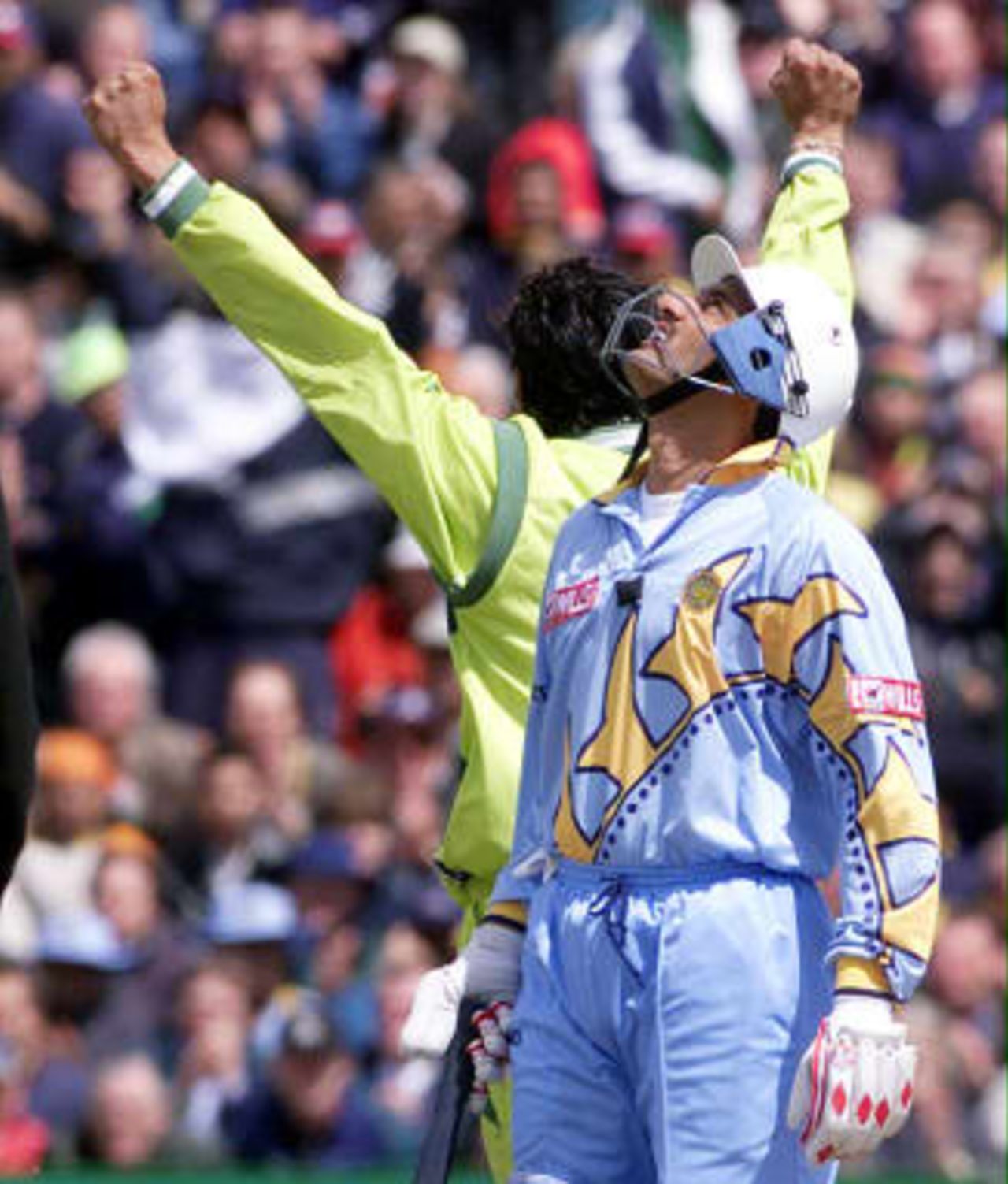 Wasim Akram holds up his hands as India's Mohammad Azharuddin looks at the sky as India lost another wicket  08 June 99, during their Cricket World Cup match at Old Trafford, Manchester