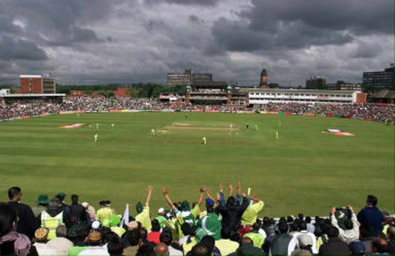 Pakistan supporters cheer on their side beneath threatening skies during their Cricket World Cup match against India at Old Trafford 08 June 1999.