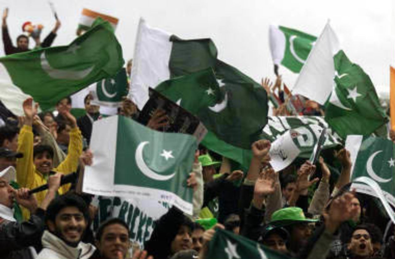 Pakistan cricket fans cheer on their side during the Cricket World Cupmatch against India at Old Trafford 08 June 1999.