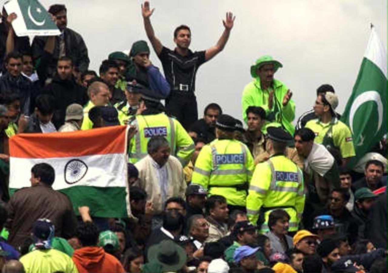 Police keep a close eye on Pakistani and Indian supporters during their Super Six Cricket World Cup match at Old Trafford, Manchester 08 June 1999.