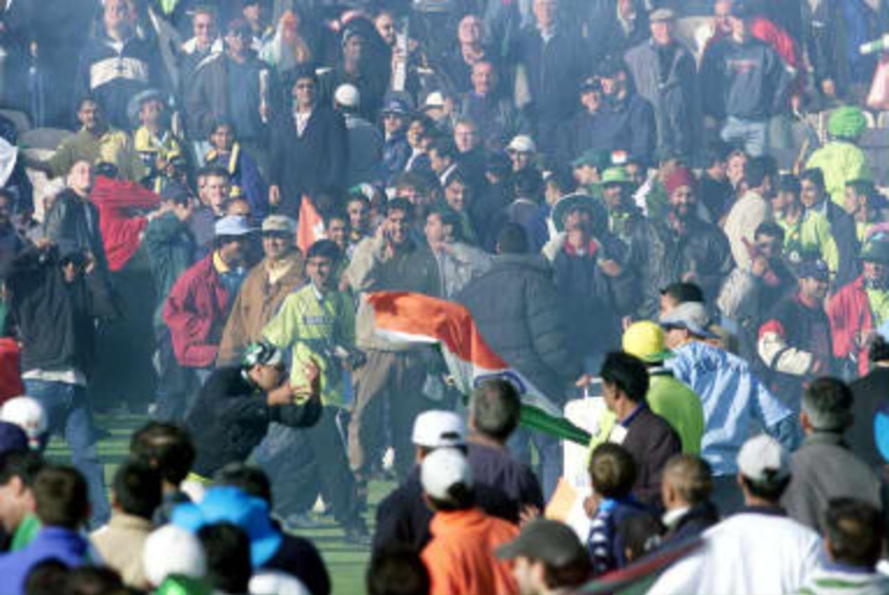 An Indian and Pakistani fan battle through the haze of firework smoke after India beat Pakistan at the end of their cricket World Cup match at Old Trafford, Manchester. 08 June 1999.