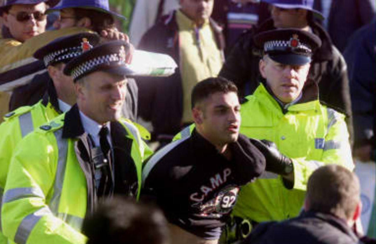 A Pakistani fan is arrested at the end of their cricket World Cup match against India at Old Trafford, Manchester. 08 June 1999.