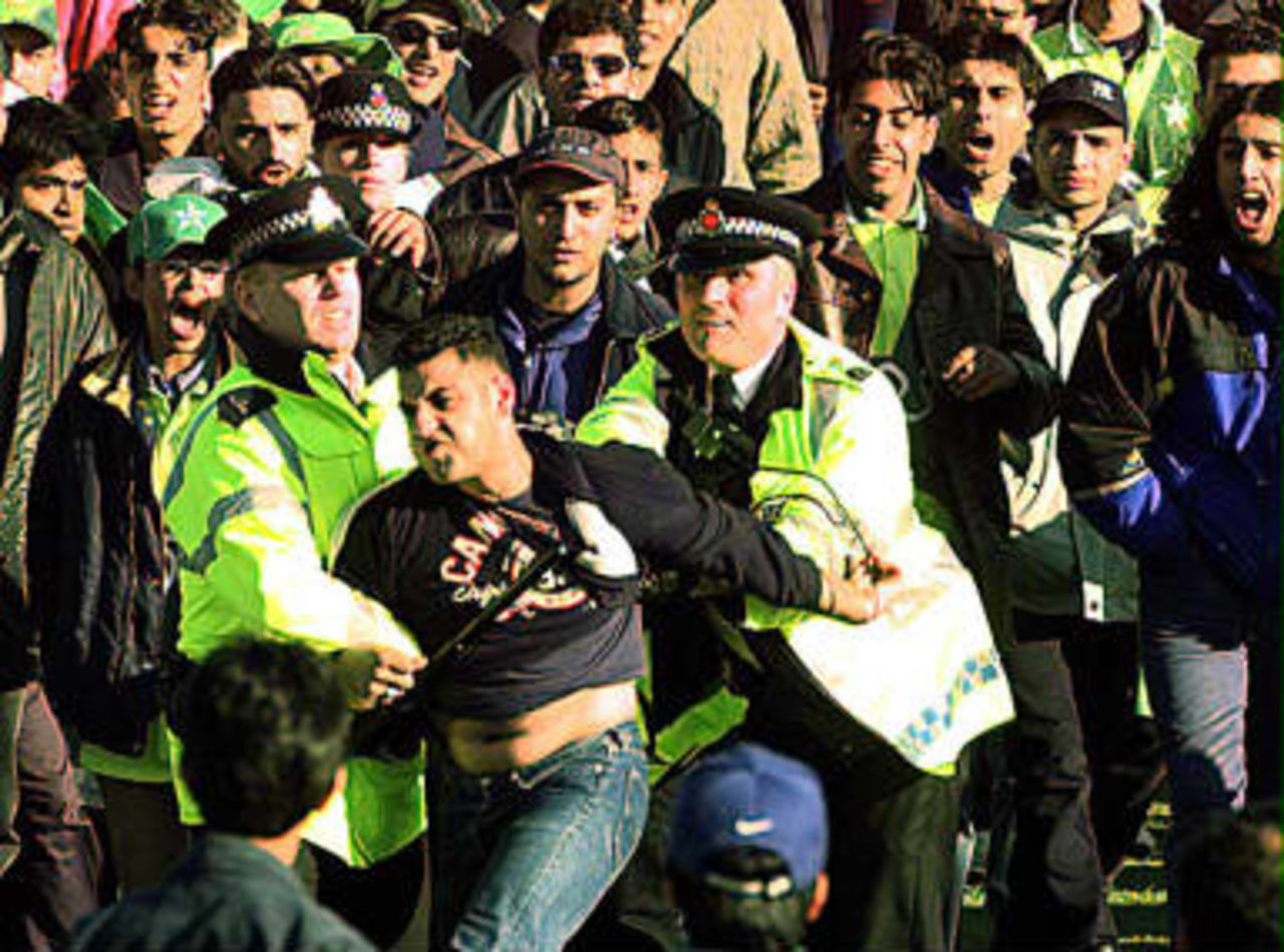 Police arrest a Pakistan cricket fan during a disturbance at the end of the India vs Pakistan Super Six World Cricket Match on Tuesday at Old Traffod, Manchester. 08 June 1999.
