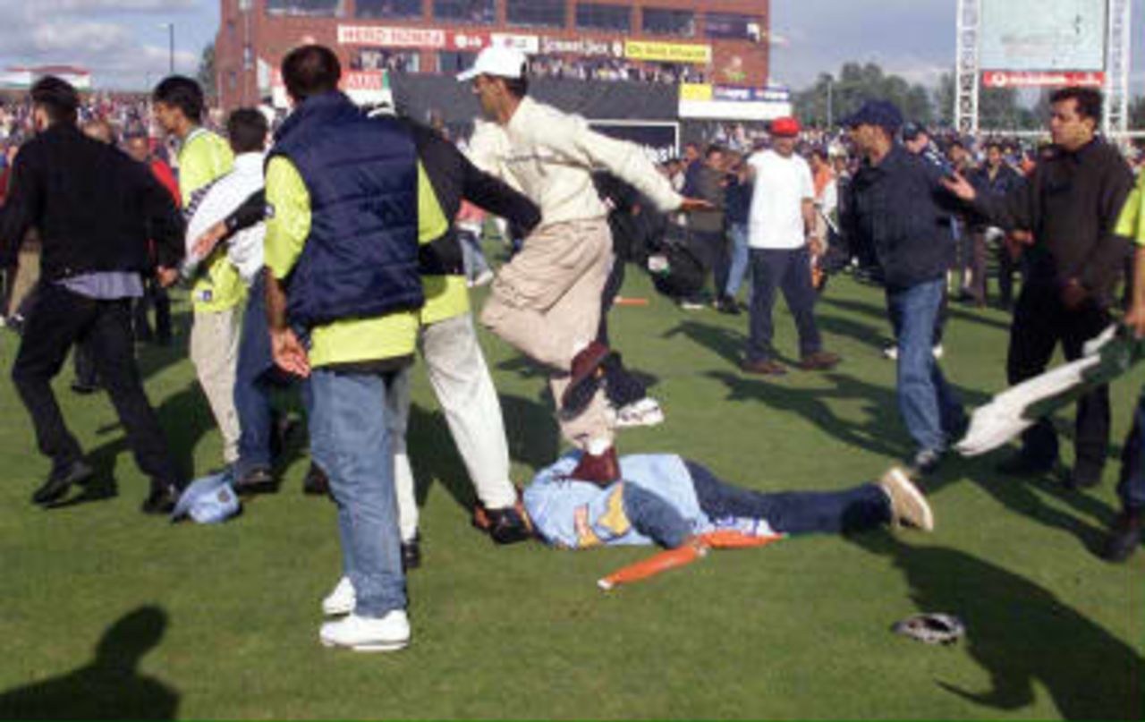 An Indian fan is kicked in the head and stamped on after the India win over Pakistan in their Super Six Cricket World Cup match at Old Trafford in Manchester. 08 June 1999.