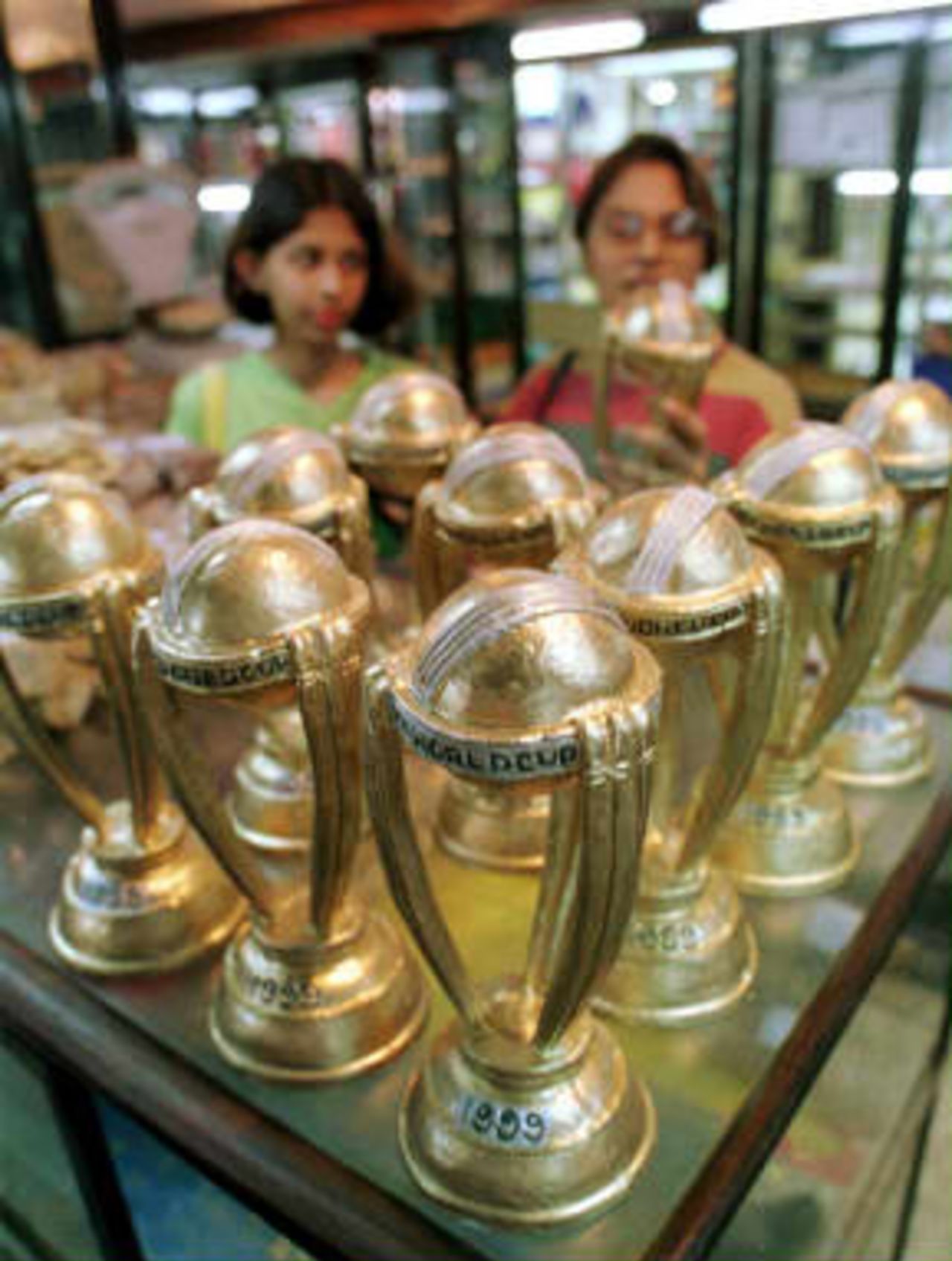 Miniature replicas of the cricket World Cup trophy made of papier mache are sold for 60 rupees each (1.50 USD) in a shop in Calcutta 09 June 1999. After India's victory over arch-rival Pakistan in their World Cup cricket match in England 08 June, Calcuttans have thronged to buy World Cup souvenirs in hopes of an India victory in the championships