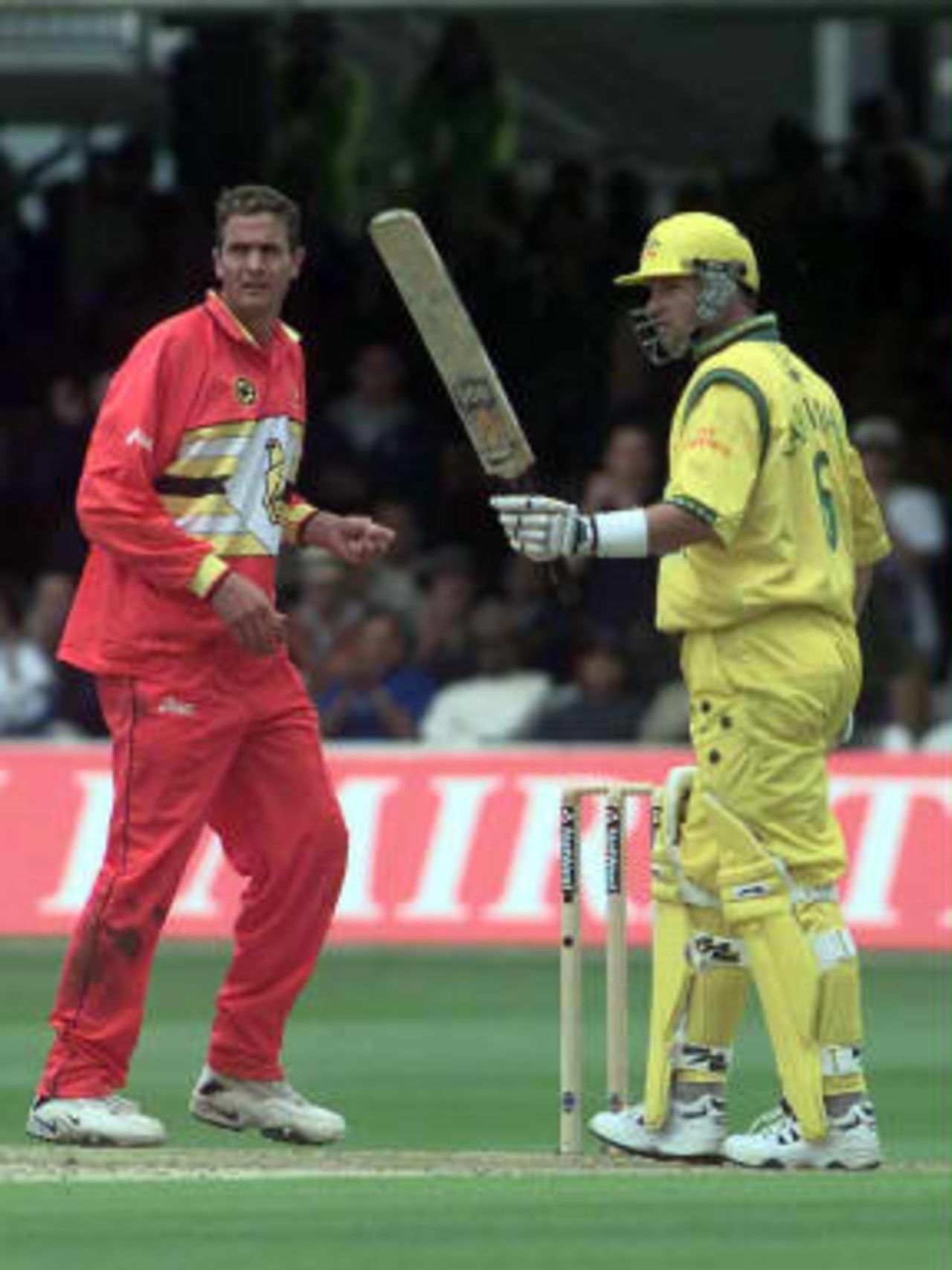 Australian batsman Mark Waugh (R) celebrates his century during their Cricket World Cup match against Zimbabwe at Lords in London, 09 June 1999