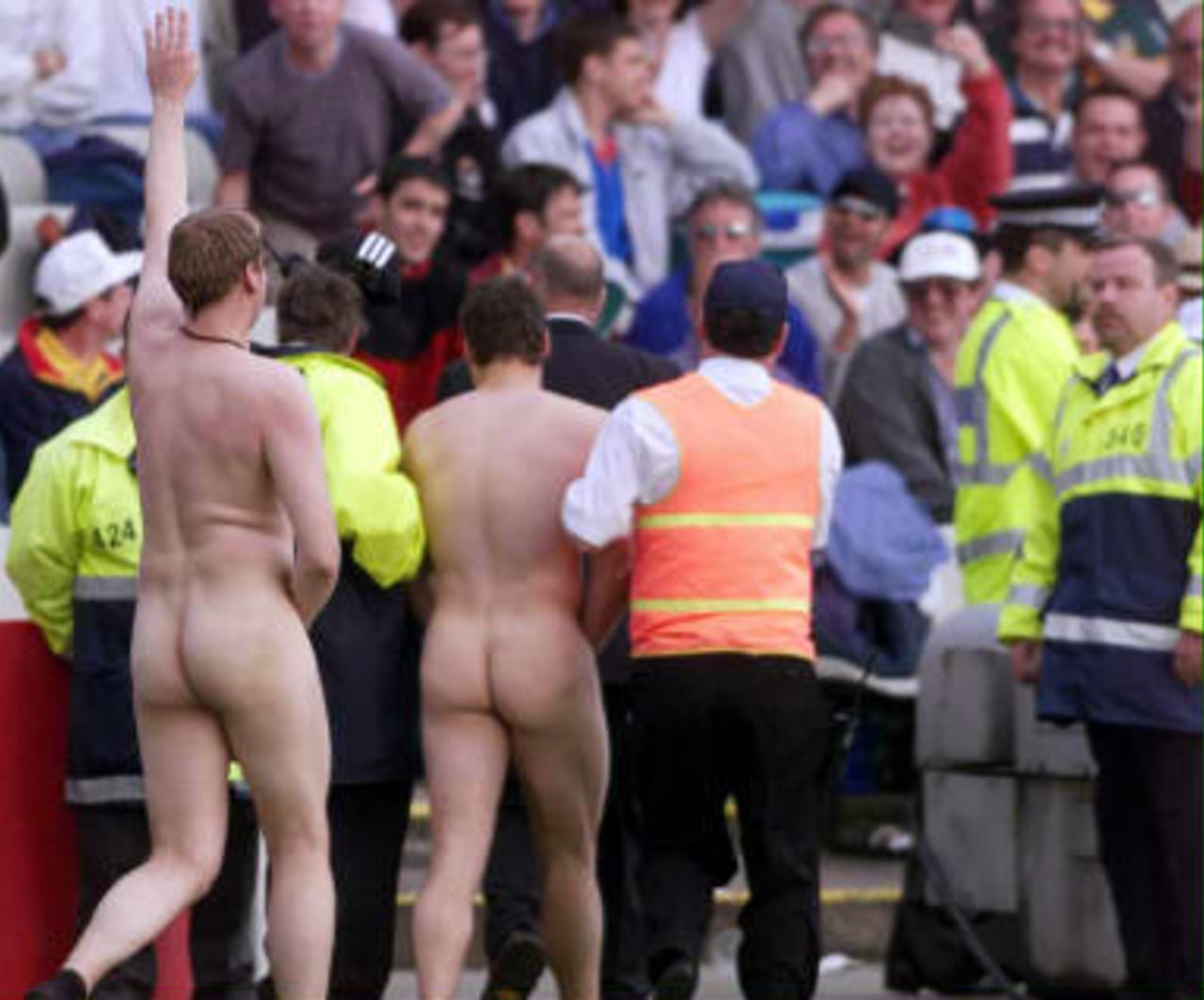 Two streakers are escorted from the pitch after disrupting play during the Super Six match between South Africa and New Zealand in the Cricket World Cup at Edgbaston, Birmingham.