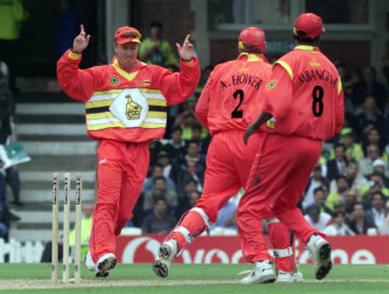 Murray Goodwin of Zimbabwe runs to congratulate Andy Flowers the wicket keeper after they had run out Ijaz Ahmed of Pakistan during  the Cricket World Cup match  at the Oval, London, Friday June 11,1999