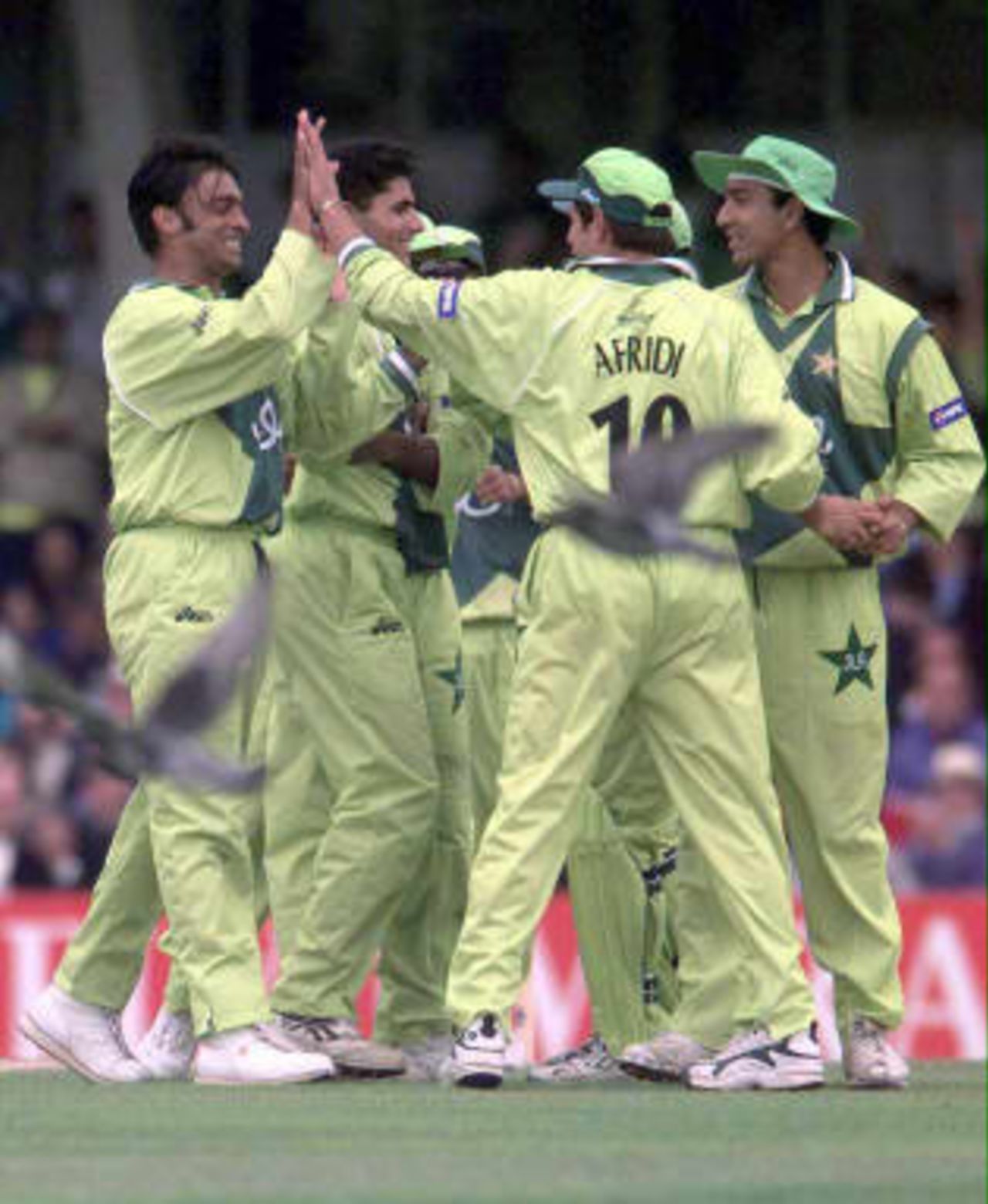 Pakistan team mates congratulate bowler Shoaib Akhtar, left, following the dismissal of Zimbabwe's Grant Flower for two runs during today's  11 June 1999 Cricket World Cup Super Six match at The Oval, London