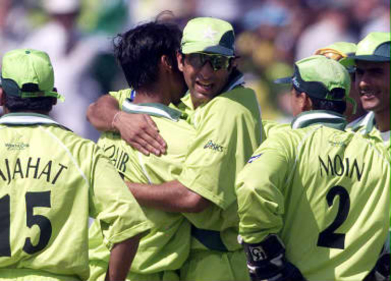 Pakistan's fast bowler Shoaib Akhtar (2nd L) is hugged by captain Wasim Akram after taking the wicket of New Zealand's opening batsman Nathan Astle 16 June 99,  during the semi-final match in the Cricket World Cup at Old Trafford, Manchester. The final will be at Lords on the 20 June