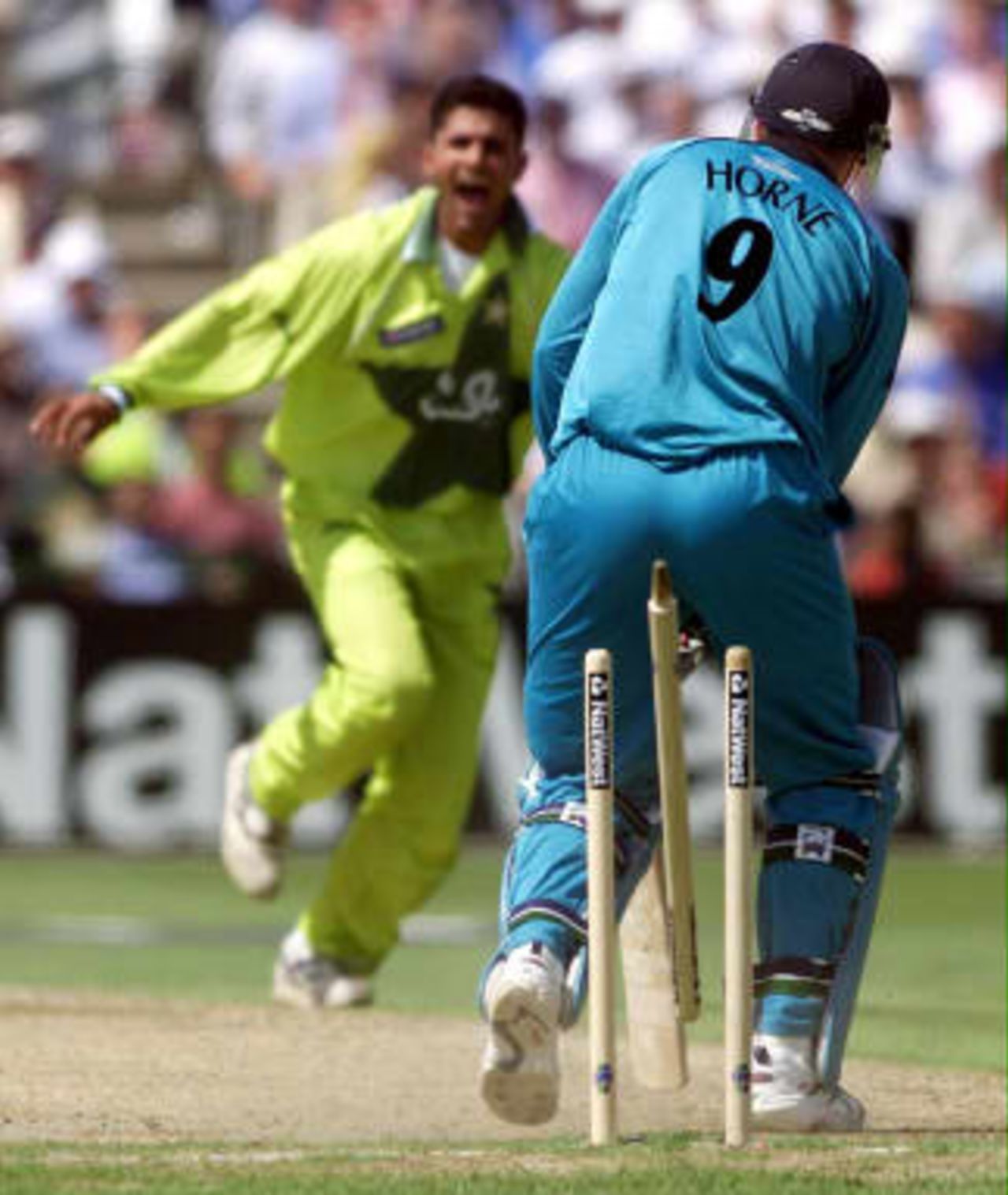 Pakistan's Abdur Razzaq (L) celebrates as he bowls New Zealand's opening batsman Mathew Horne middle stump 16 June 1999,  during their semi-final match in the Cricket World Cup at Old Trafford, in Manchester. The final will be at Lords on the 20 June 99