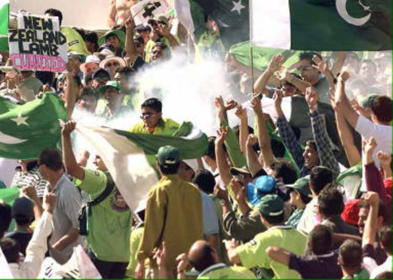 Pakistan supporters let off firecrackers and smoke bombs as their side play New Zealand in the World Cup Cricket Semi Final at Old Trafford, Manchester, 16 June 1999.