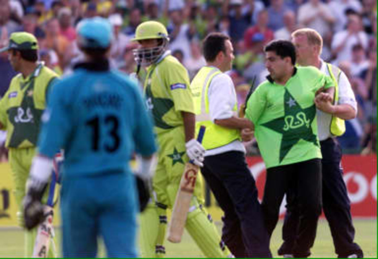 Pakistani fan is arrested after a pitch invasion six runs before Pakistan's win over New Zealand 16 June 1999 in the semi-final match in the Cricket World Cup at Old Trafford, Manchester. The final will be at Lords