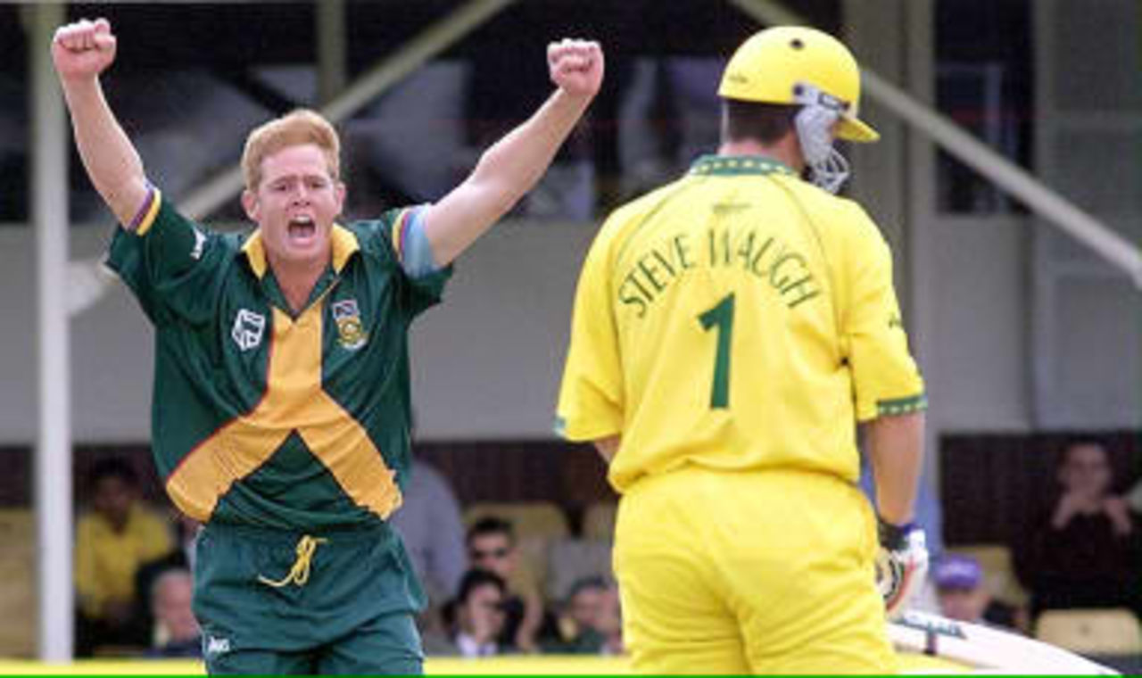 Shaun Pollock (L) of South Africa celebrates taking the wicket of Australian Captain Steve Waugh in their Cricket World Cup semi-final at Edgbaston in Birmingham 17 June 1999