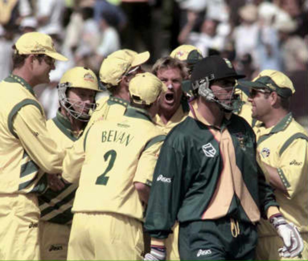 Australia's Shane Warne (centre facing) being congratulated by teamates and screams after bowling  South Africa's captain Hasie Cronje for a duck, during today's, Cricket World Cup semi final at Edgbaston, 17 June 1999