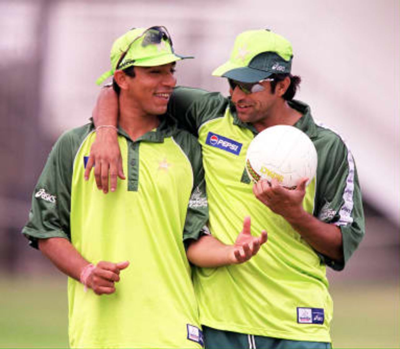 Two members of the Pakistani cricket team smile as they warm up on the hallowed turf of Lord's cricket ground in London before the Cricket World Cup final on 20th June between Pakistan and Australia.